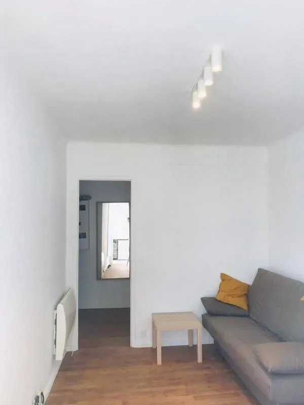 Séjour avec canapé et porte d'entrée